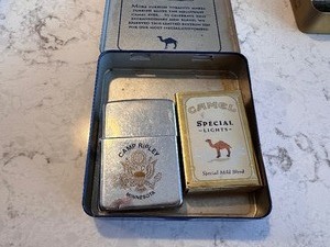 lot 201 image: 1985 Zippo Camp Ripley Minnesota Lighter with Package of Camel Special Lights Matches in a Camel Turkish Silver Tin