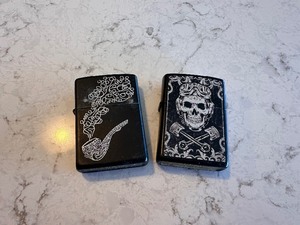 lot 234 image: Zippo Black Matte Skull Wrenches and Smoke Pipe Black Ice Finish Lighters