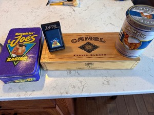 lot 239 image: Variety of Camel Items - Camel Tobacco Barrel, Camel Pine Box, Camel Zippo Lighter and Smokin Joes Racing Box
