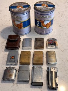 lot 212 image: Variety of 11 Vintage Zippo and other Lighters including a Vintage Leather Camel Lighter Case and Two Camel Tobacco Cans