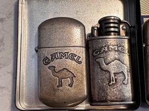 lot 198 image: Two Vintage Camel Lighters in Black and Blue Camel Premium Cigarettes Filters Tin