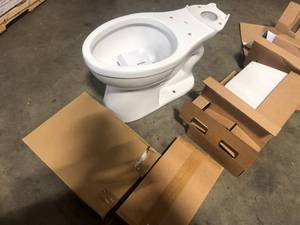 lot 14 image: Delta Foundations 2-Piece 1.28 GPF Single Flush Elongated Toilet in White  Customer Returns See Pictures