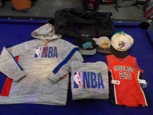 lot 120 image: 2 NBA hoodies 1 is M, 1 is L, new chicago #23 jersey size M56, timberwolves duffel, NBA hats
