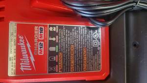 lot 86 image: Milwaukee Hard Case wBrand New M12M18 Battery Charger (New)