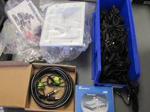 lot 26 image: Part Organizer Bin full of Monster brand Aux cords, LED digital bed light sensor switch and other accessories