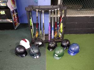 lot 123 image: Bats, Rubbermaid bat stand, and baseball safety helmets