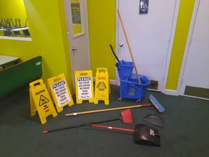 lot 214 image: (4) Yellow Warning Signs. Wringer mop bucket and mop. Libman upright dustpan, an angle broom, a push broom,