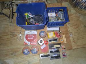 lot 220 image: 2 tubs of small tools Includes Grinding wheels, ripping blades, trowels, hammers, gloves, bolts, Simpson Strong-tie connectors