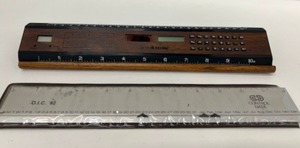lot 435 image: Vintage Brookstone MCM Look Solar Calculator, Clock, Ruler & Control Data Advertising Calendar Ruler
