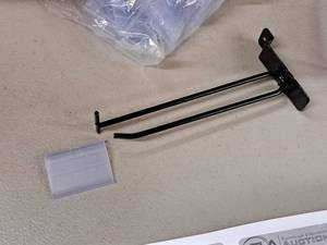 lot 1304 image: Lot of (29) 7 Slat Wall Pegs with Price Tag Holders