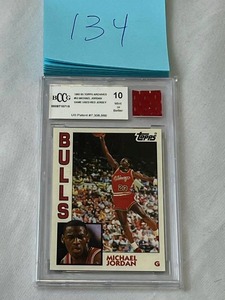lot 134 image: RARE 1992-93 Topps Archives #52 Michael Jordan Game Used Red Jersey Card (BCCG 10)