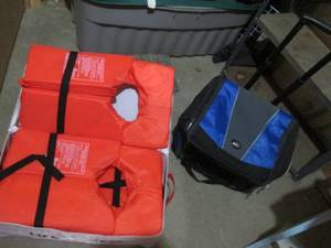 Zip enclosed bin of life vests and an insulated rolling cooler