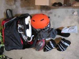 Duffle bag full of assorted sports gear