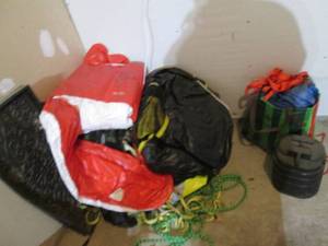 Assortment of tarps, water skiing supplies and fear, gutter pan and other outdoor misc