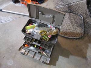 Mid-sized Plano Tacklebox full of assorted fishing gear and supplies plus a fishing net