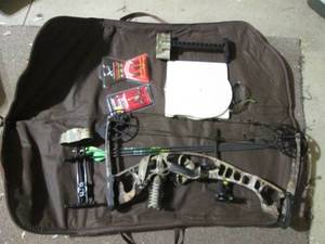 Camo Hoyt Right-Handed Compound Bow and Mossy Oak camo gear bag full of assorted hunting supplies