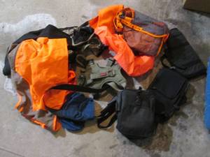 Assortment of human and canine hunting gear, handgun cade and more