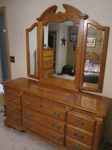Ladies Webb solid wood 9-drawer dresser featuring brass tone hardware and carved detail throughout. Includes detachable 3-section arched hinged mirror (matches lots 5 &amp 6)
