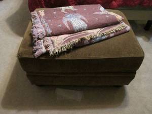 32 Padded Ottoman covered in Upholstered shades of brown, includes decorative throw blanket