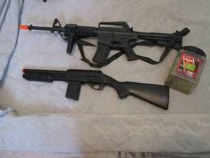 Mossberg M590 Pump action airsoft shotgun and machine gun style airsoft gun with partial container of air soft