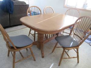 Ornately detailed 60 Kitchen dual pedestal style Table and 5 matching spindle back wood chairs. Includes 2-leafs underneath for expansion