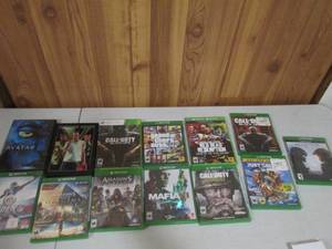 Stack of assorted XboxOne and Xbox360 video games