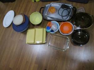 Covered tote full of misc Tupperware and other kitchen supplies