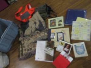 Clamshell tote full of new and pre-owned products such as photo albums, gift sets, coolers and more