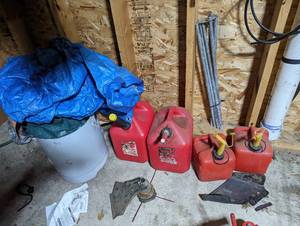 Assortment of tarps and gas cans