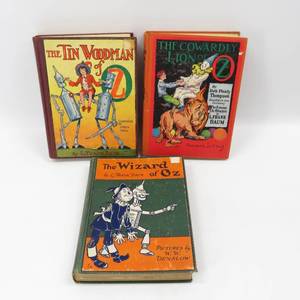 lot 250 image: Antique Lot of 3 Wizard of Oz Themed Books, The Tin Woodsman, The Cowardly Lion, The Wizard of Oz