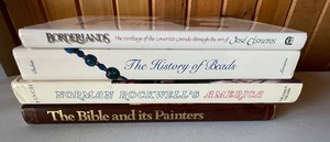 lot 230 image: Lot of 4 Hardcover Books, History of Beads, Norman Rockwell, Bible and its Painters and Borderlands