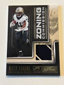 lot 221 image: Alvin Kamara Relic 2018 Playbook Zoning Commission #18 Player-Worn Football Card