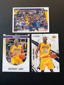 lot 253 image: Kobe Bryant 3 Card Lot - 1997 UD Collectors Choice #64, 2010-11 Rookies and Stars #90, 2012 NBA Hoops #268 Basketball Cards