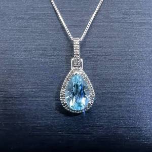 lot 38 image: Natural Blue Topaz Pear Solitaire & Diamond Halo Drop Pendant in White Gold $950 Retail