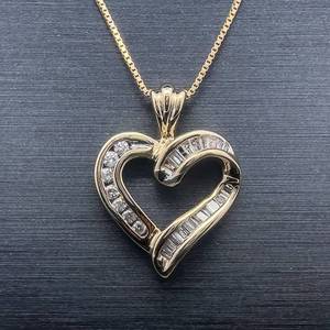lot 69 image: Petite Round & Baguette Diamond Open Ribbon Heart Pendant in 14k Yellow Gold $1,380 Retail