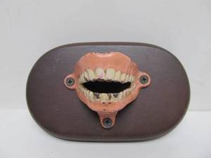 lot 122 image: Original 1930s Cast Iron Wall Mount Bottle Opener - Open Mouth wTeeth