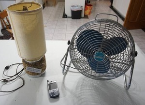 lot 77 image: Home Essentials...MCM Cork Base Lamp, Montgomery Wards Table Top Fan, Sprint Phone...