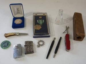 lot 199 image: RARE Collectibles...1950s Sterling Buddha Siam Lighter Repousse Silver Zippo Style, Vintage Ronson Varaflame Windlite Lighter, US Military Medal, Vintage Finger Rosary Silver Ring,, Pocket Knife Etc.