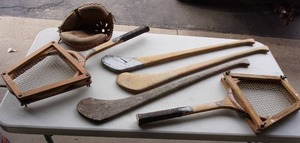 lot 292 image: Vintage Sporting Goods...Sportflite Professional Tennis Rackets, Antique Hurling Sticks, Holiday Baseball Catchers Mitt Etc.