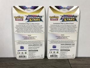 lot 12 image: POKEMON BRILLIANT STARS Flapple & Eevee Booster Packs (2 - Unopened packs with coin in the front)
