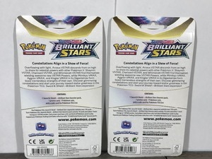 lot 14 image: POKEMON BRILLIANT STARS Flapple & Eevee Booster Packs (2 - Unopened packs with coin in the front)