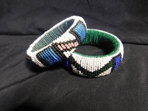 lot 307 image: 2 Beaded bracelets, curtain tie backs, battery tester and angel lamp topper
