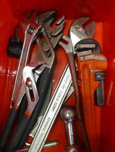 Bin of pipe wrenches, crescent wrenches, Ridgid, Snap-on, lathe handle