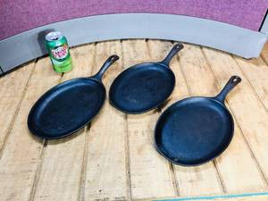 lot 27 image: 3 Lodge Cast Iron OS 10 Oval Skillets