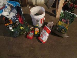 lot 124 image: Assortment of outdoor chemicals and large open bags of bird seed