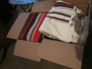 lot 90 image: Two boxes containing quilts and afghans