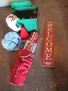 lot 108 image: Covered tote of Christmas decor, Tall wooden welcome sign and canvas gift wrap zip storage bag