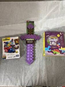 lot 37 image: Minions Toy, Minecraft Enchanted Sword, and Dinosaurs Soap Lab