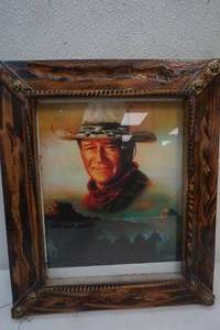 lot 534 image: John Wayne picture with wood frame