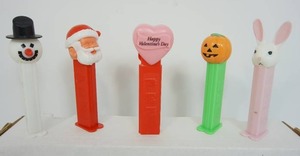 lot 48 image: Vintage Collectible Toy Pez Dispensers Including Pink Heart Red Stem Happy Valentines Day Hungary, Easter Bunny Light Pink White Slovenia, Santa Claus wEyes Closed, Snow Man 1990s Slovenia, Halloween Pumpkin Jack-O-Lantern wLime Green Stem Hungary...